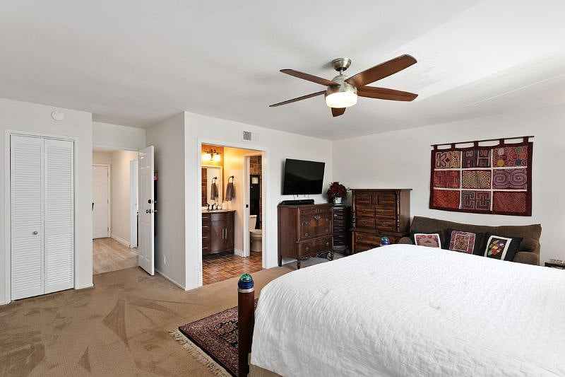 Master bedroom and private bath. Carpet has been replaced with plank flooring.