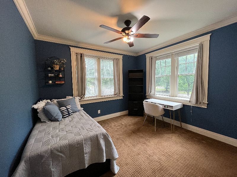 Second bedroom with twin bed that easily converts to a king bed, a desk, a large closet, tons of natural light, and park views.