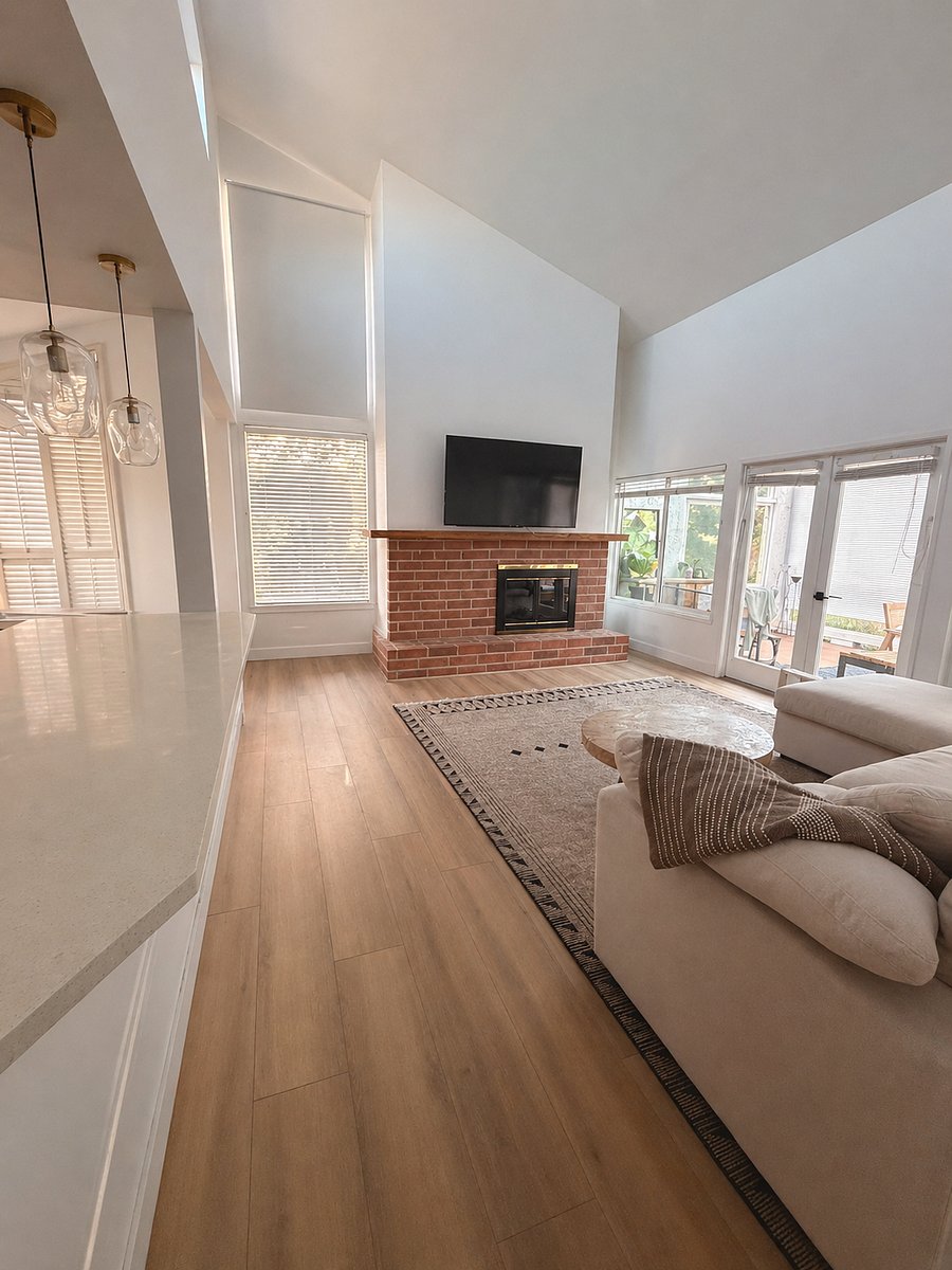 living room, kitchen to the left, patio to the right