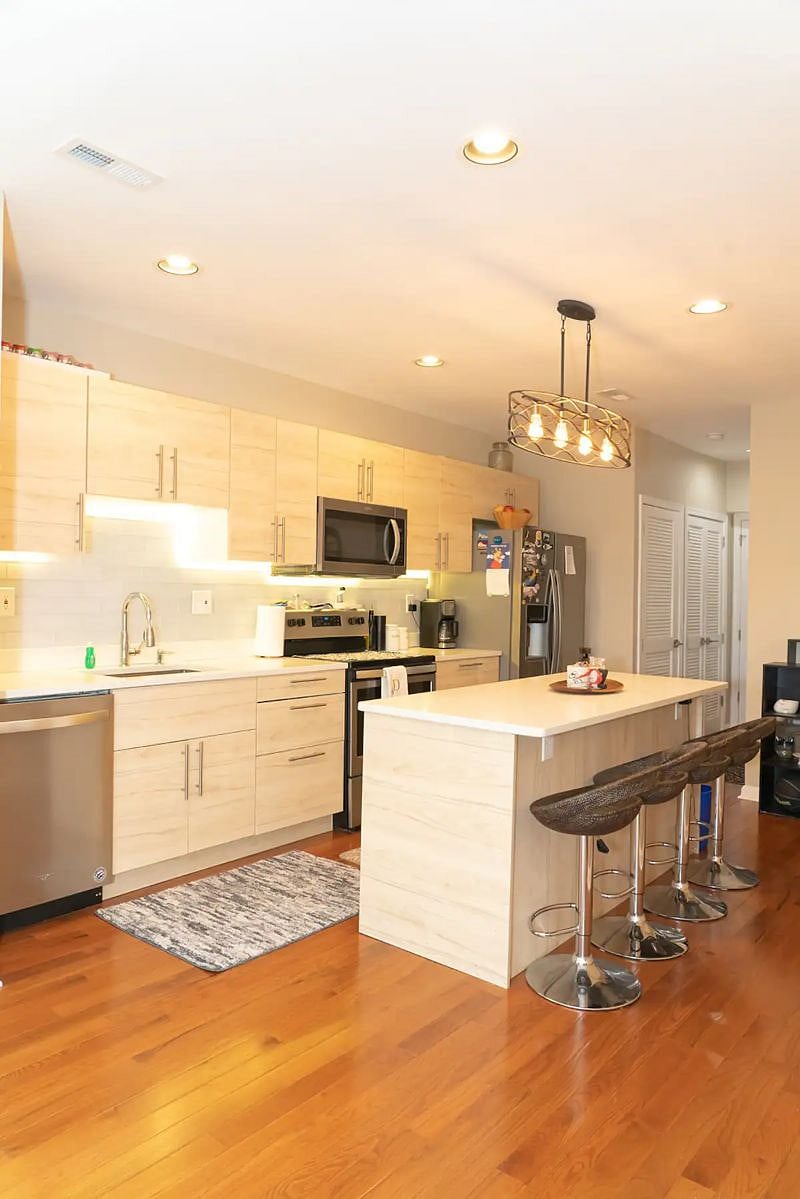 Spacious Kitchen with Island seating. includes new Whirpool full kitchen appliances: Electric Stove, Microwave, Dishwasher, and Fridge; Also has Coffeemaker, cooking/baking, dining amenities, and many things you may need for a long term stay.