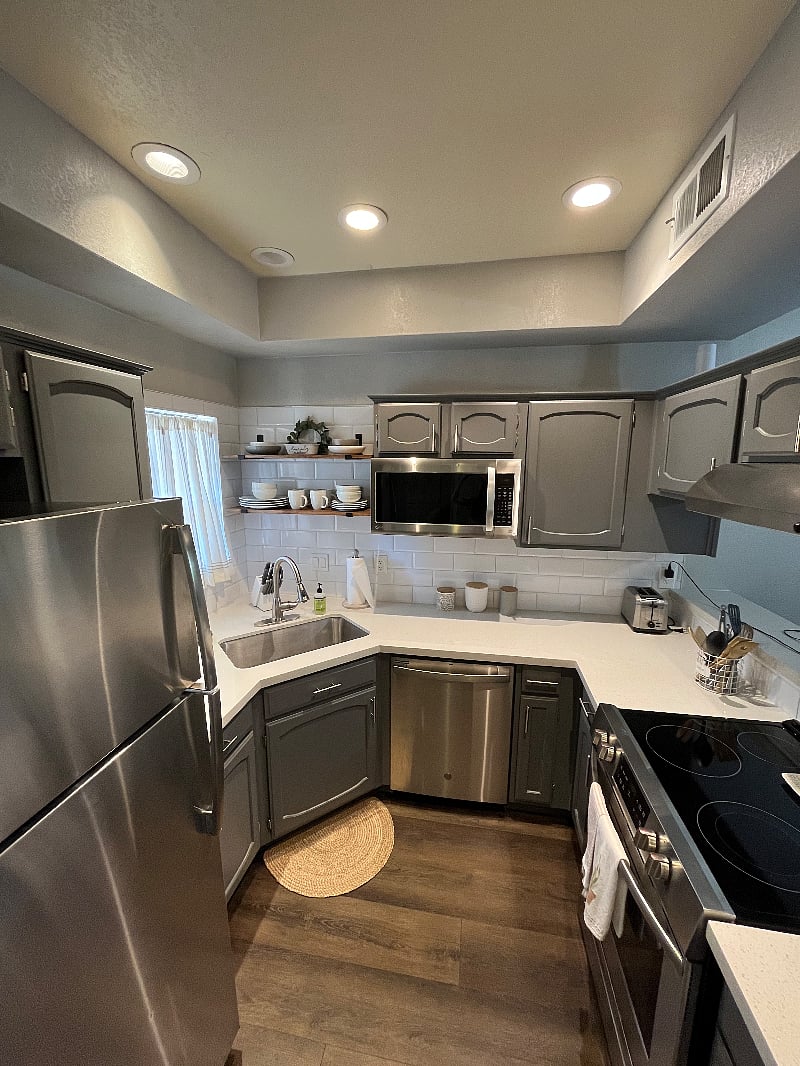 Updated kitchen with stainless steel appliances and fully equipped with dishes, silverware cooking utensils, pots, pans, coffee maker, toaster and microwave.