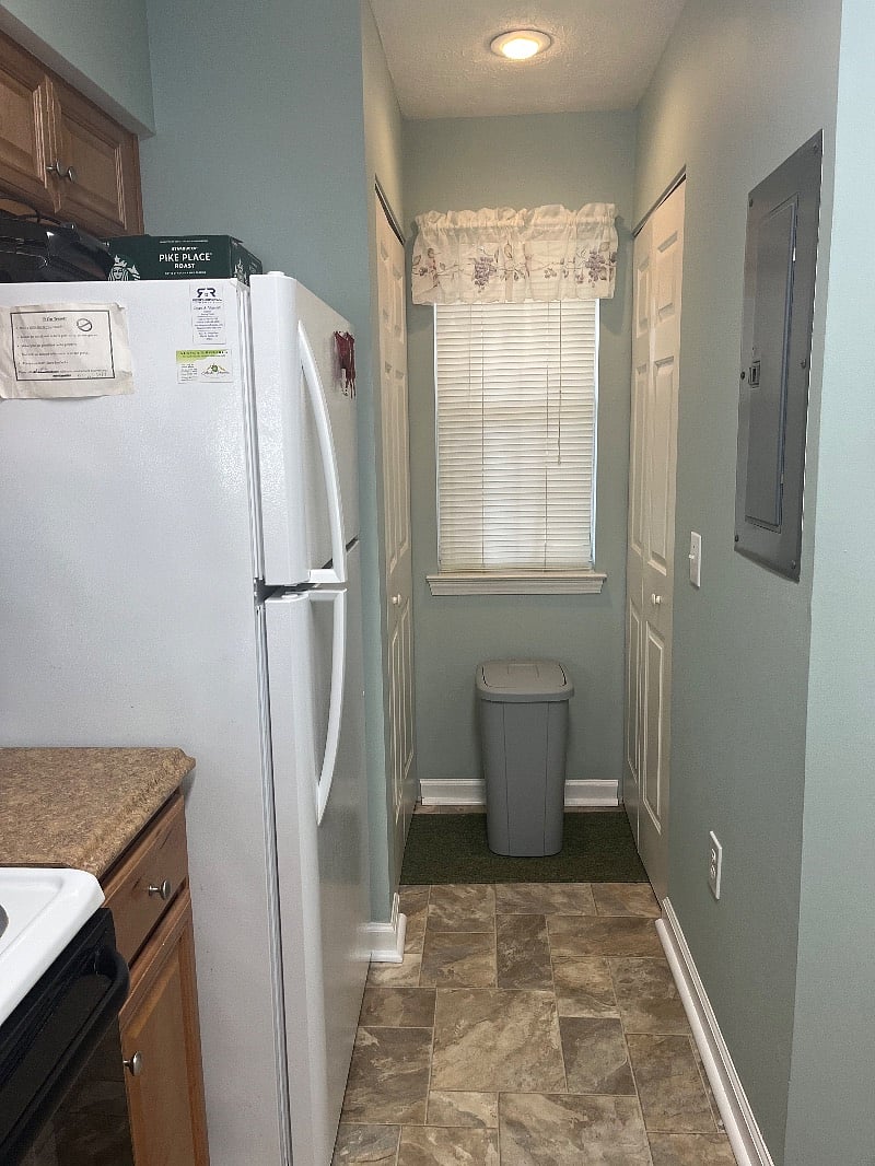 Full size washer and dryer located behind accordian doors on either side of window inside unit