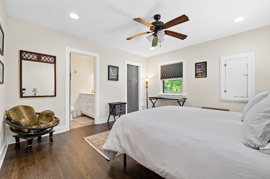 Master en suite bedroom showing ceiling fan.