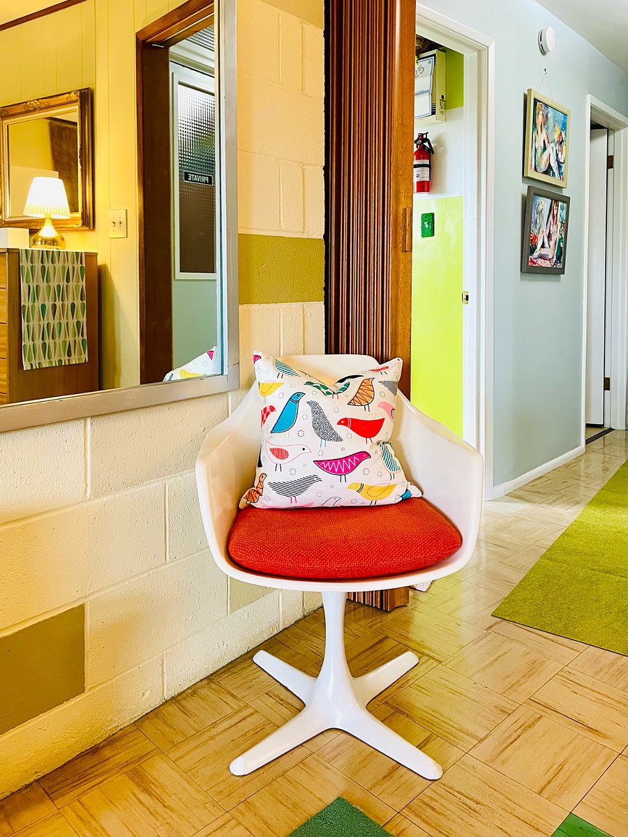 View to hallway through teak accordion door. Burke 'Propeller' fiberglass swivel chair in Knoll fabric, ca. 1970s.