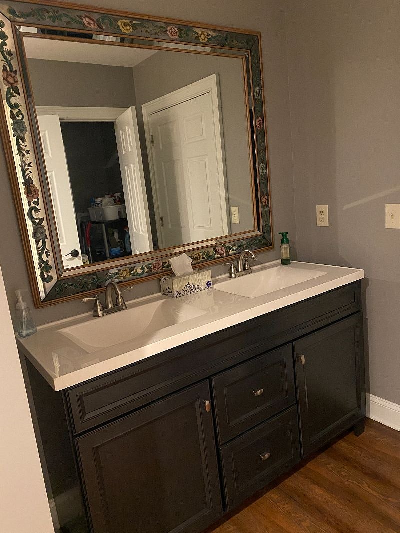 304 Suite 1 spacious bathroom with antique mirrors and stained glass window.