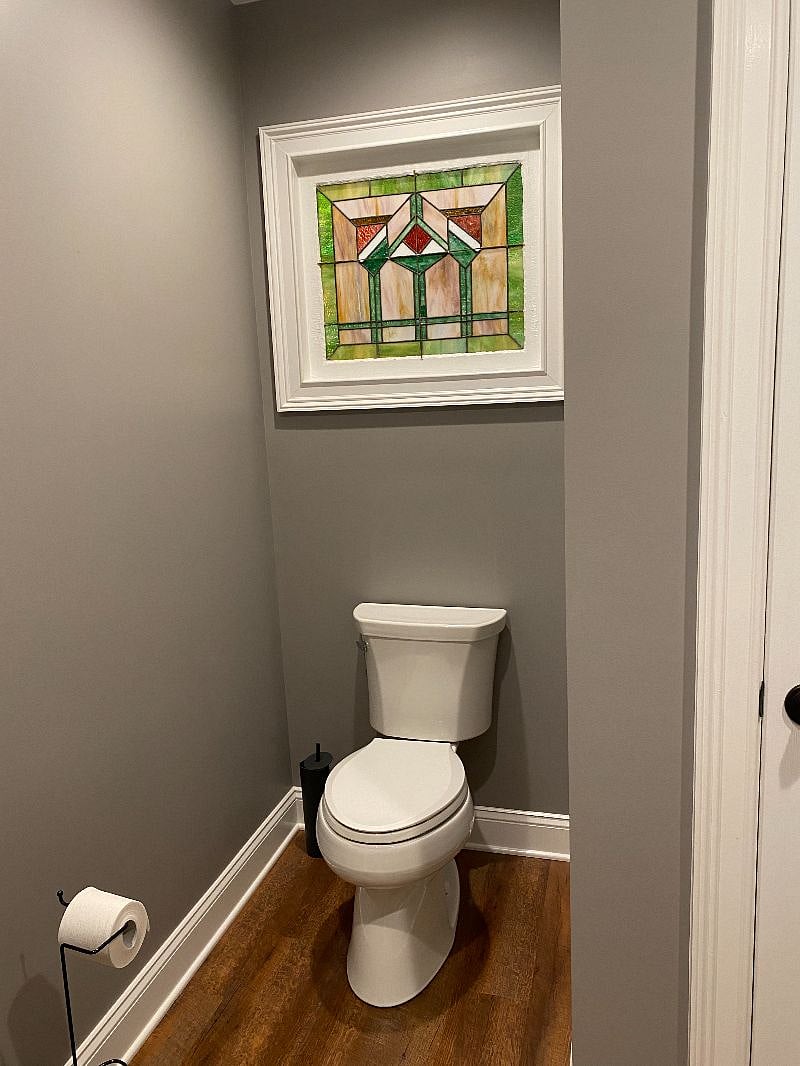 304 Suite 1 spacious bathroom with antique mirrors and stained glass window.