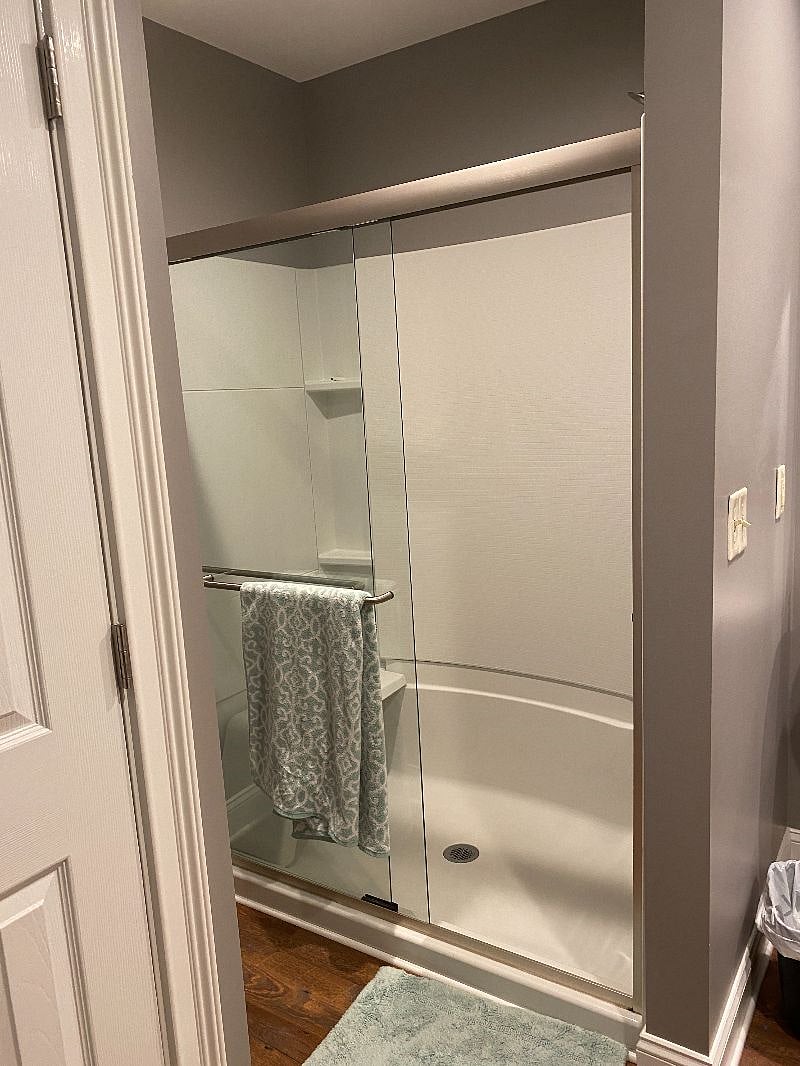 304 Suite 1 spacious bathroom with antique mirrors and stained glass window., and a 5-foot shower.