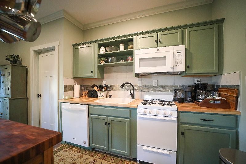 Kitchen with gorgeous tile and microwave, gas stove and oven and dishwasher.