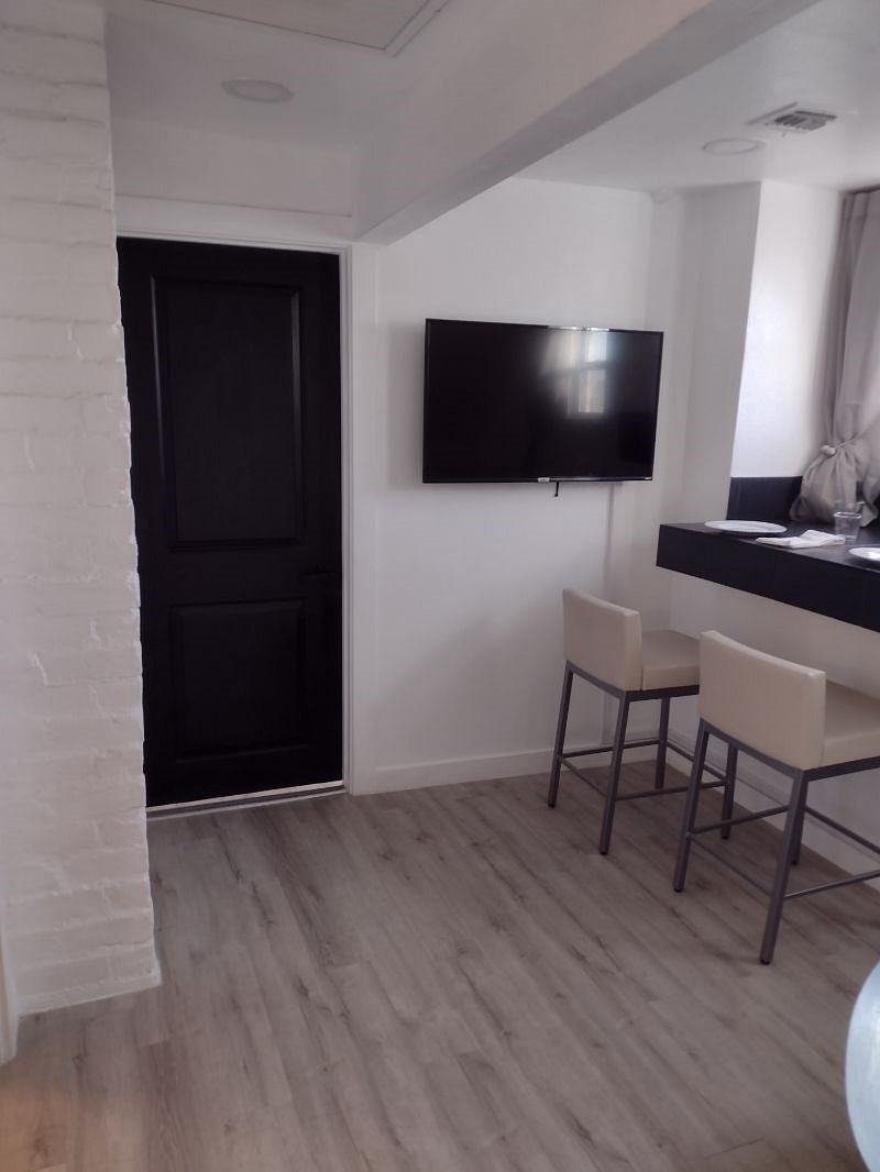 Looking at entry door and 50 inch Smart TV from living room area