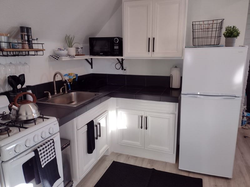 Well stocked kitchen with gas stove, microwave, fridge and lots of cookware