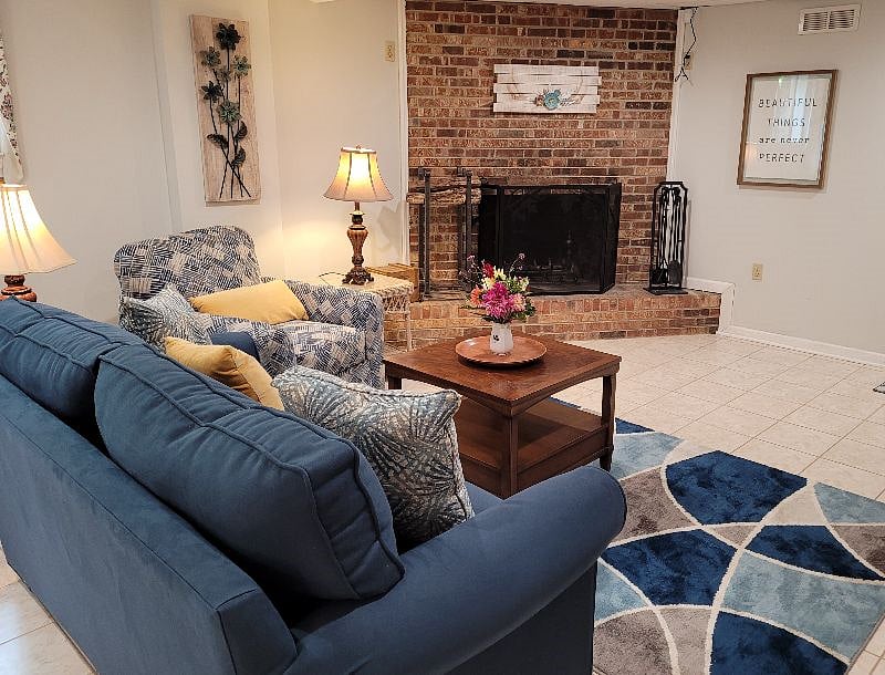 Large living room with wood-burning fireplace.