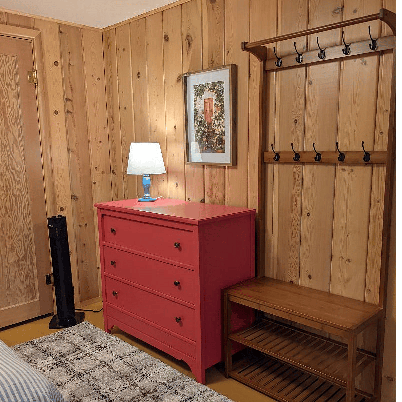 Bedroom includes oscillating fan and shoe and coat rack. Large closet not shown.