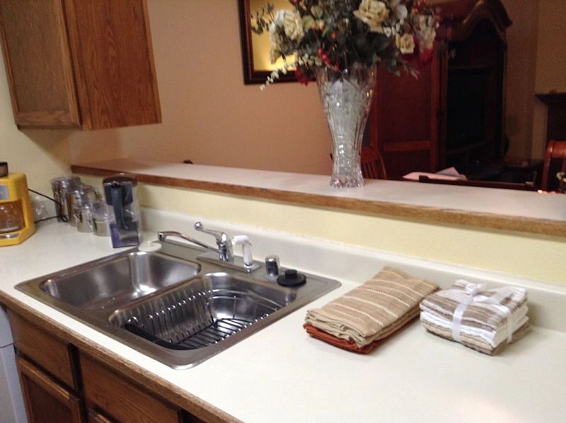 Kitchen sink area with towels.