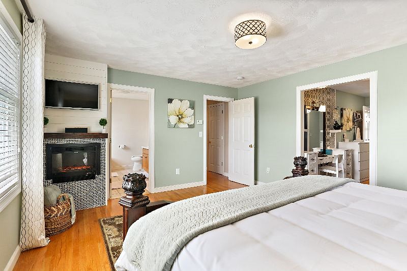Master suite with king bed and electric fireplace
