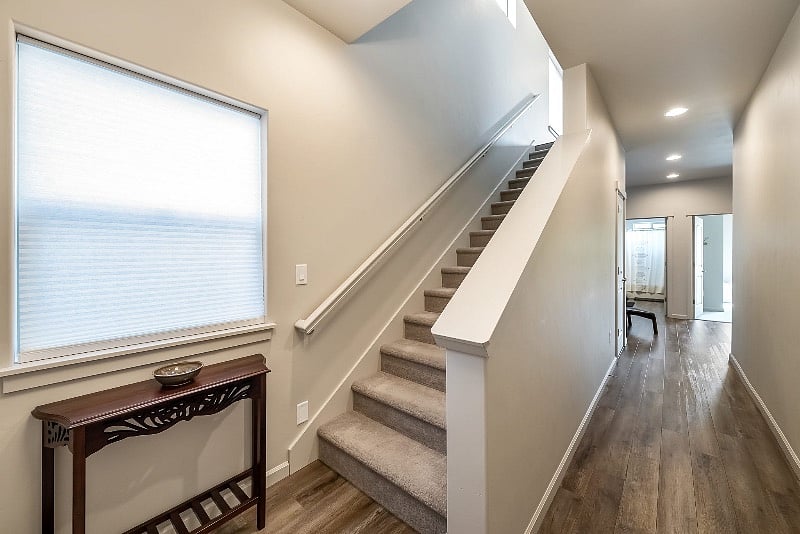 Entry area from front door and garage. Den, bedroom and full bath downstairs.