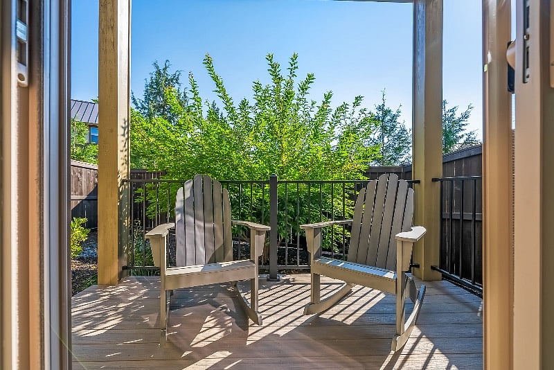 Covered balcony with seating off downstairs bedroom.