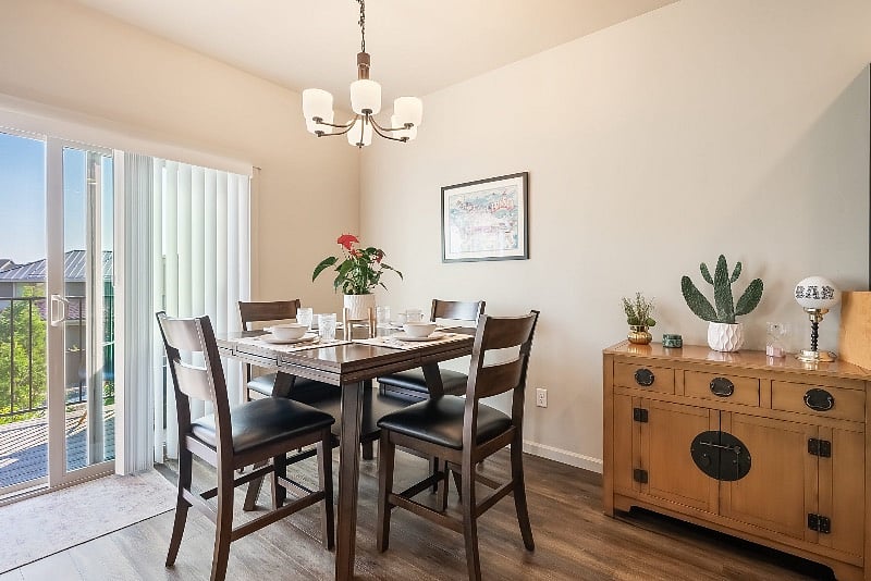 Upstairs dining room with balcony, BBQ and outdoor seating.