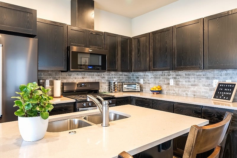 Kitchen with gas range, fridge, freezer, dishwasher & microwave.