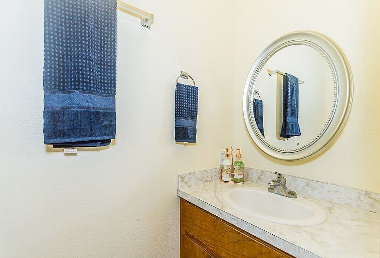 Master 1/2 Bathroom with sink, commode, new towels.