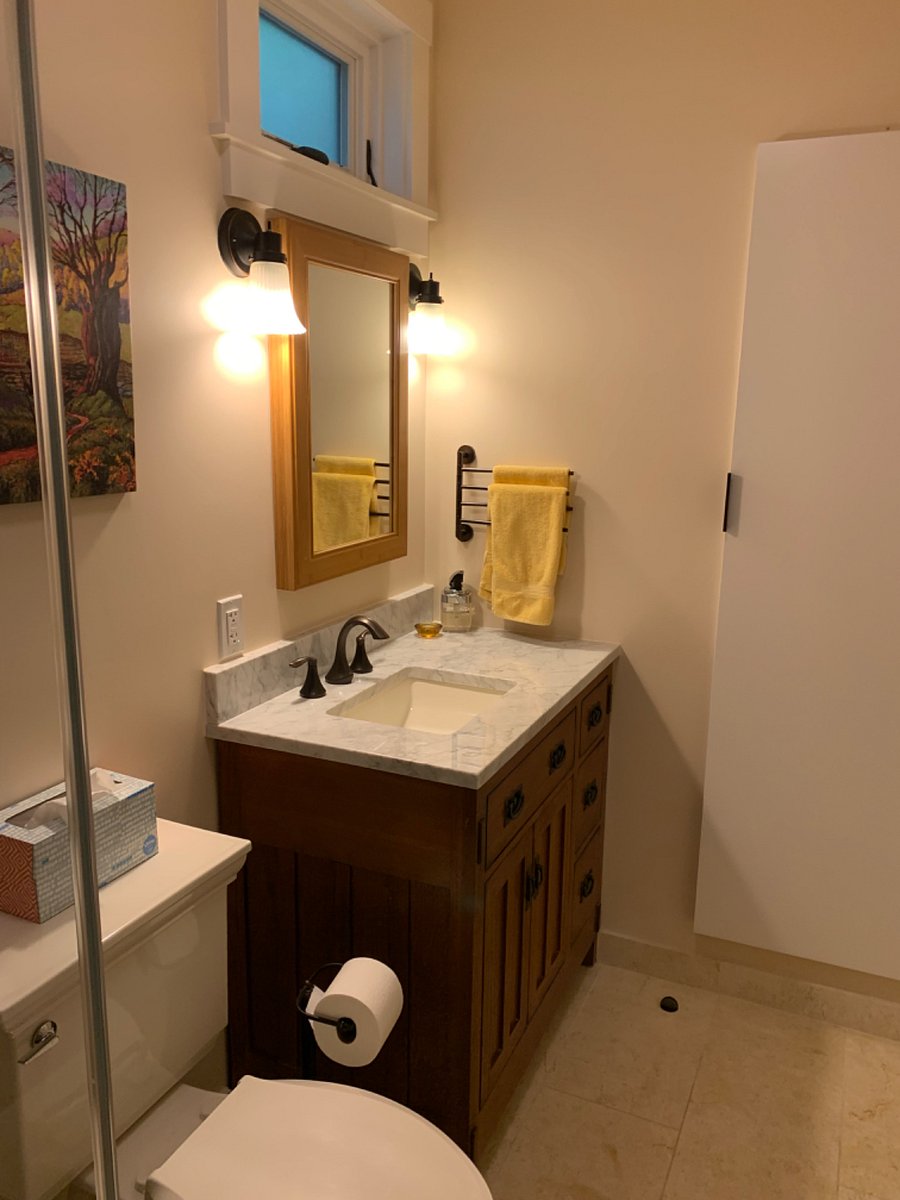 Bathroom includes large wall cabinet for additional storage
