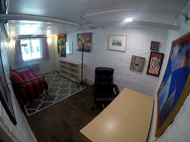 This is the second bedroom, lots of light here. Exposed brick wall. 