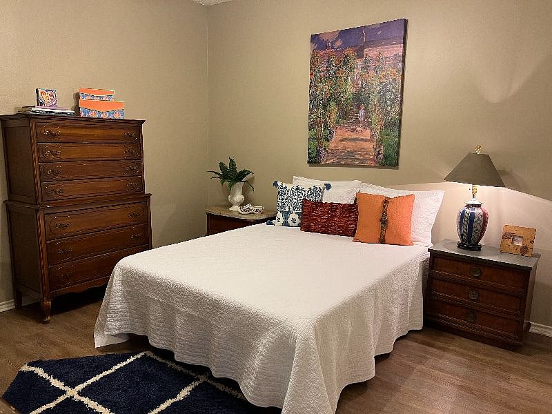 Bedroom with queen bed with new mattress and chest of drawers.
