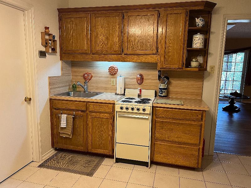 Oven, stovetop, coffee pot, fully furnished with dishes, silverware, glassware, pots, pans and storage.