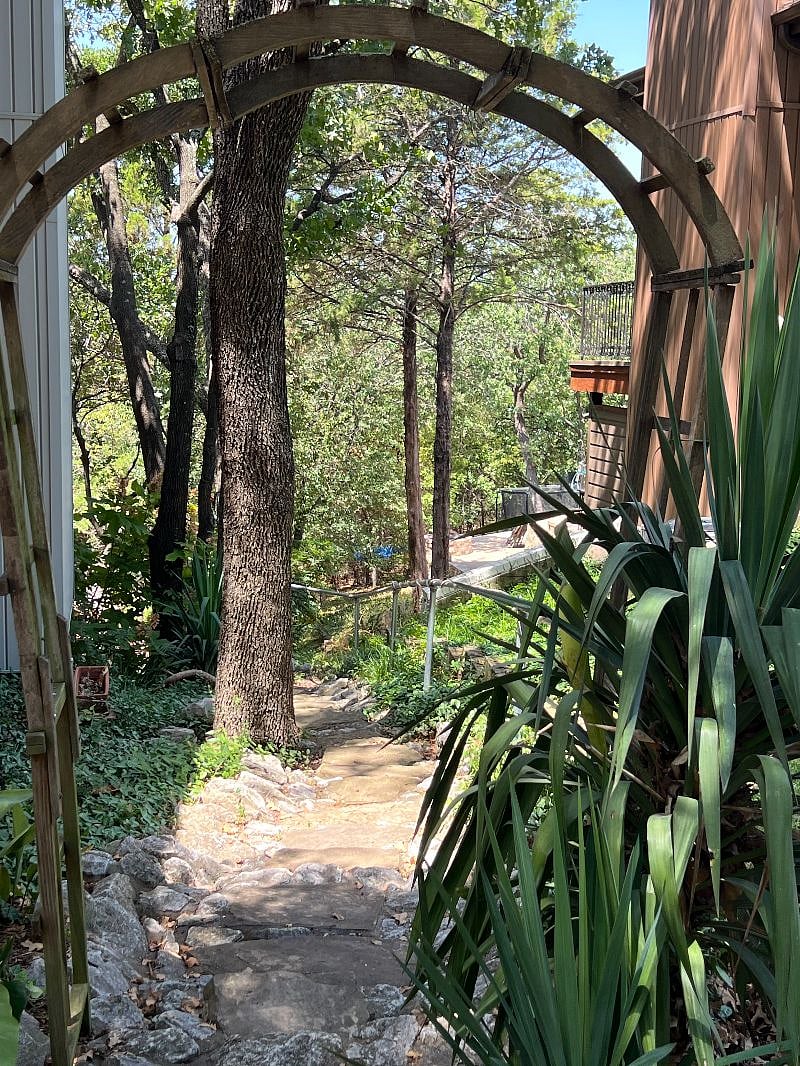 Arched entry to walkway to apartment.