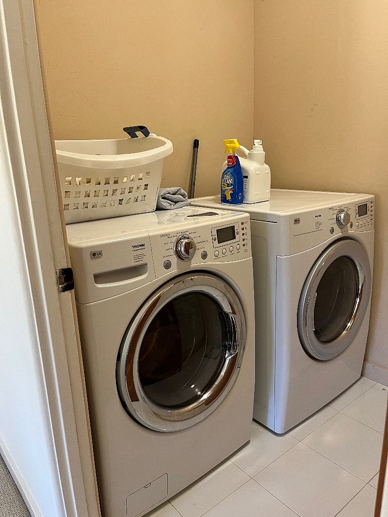 Washer, dryer and counter top in the hallway next to bedroom