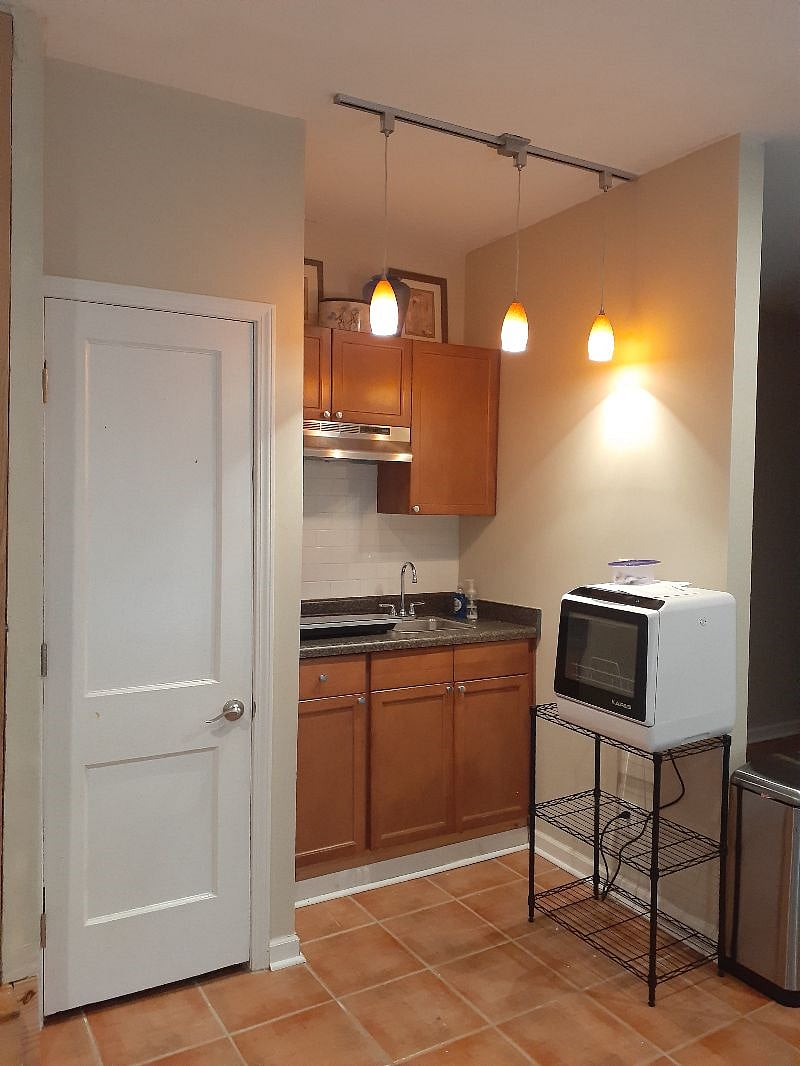 This is where you will cook your meals. Has everything you'll need. Silverware, dishware, pots & pans. Kitchenette with electronic induction cooktop, & countertop dishwasher (drains into sink).