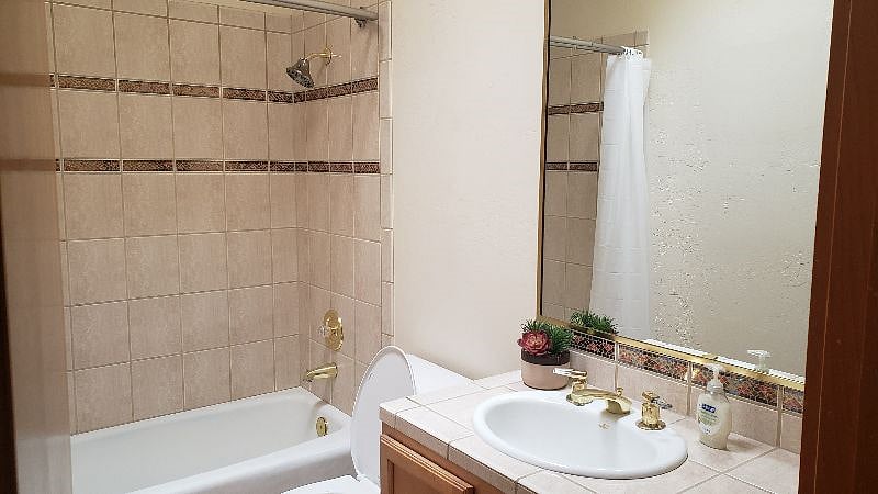 Guest bathroom located right next to second bedroom