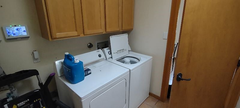 Laundry room has plenty of cabinet space and opens up to two-car garage. 