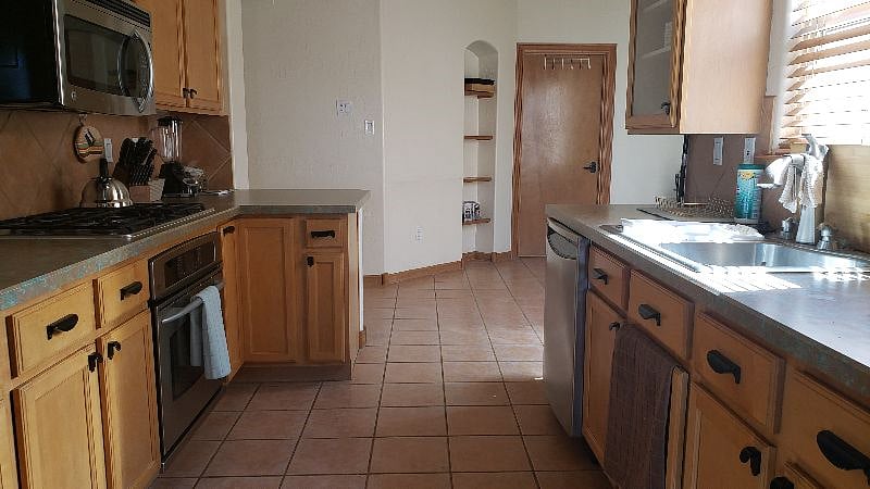 Laundry room located beyond door in the distance.