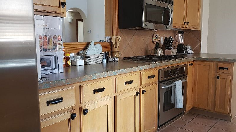 Newly purchased utensils, dinnerware, glasses, and air fryer await you.