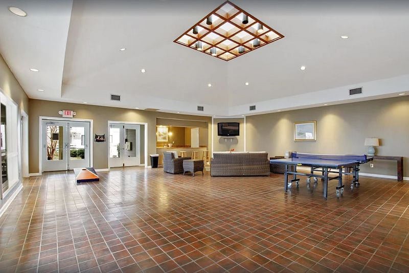 Clubhouse includes ping pong, sitting area, and corn hole.