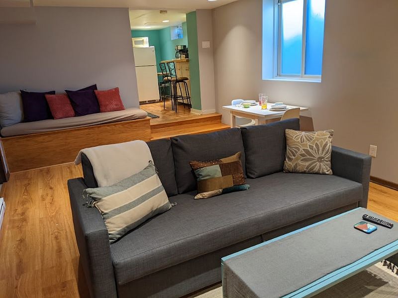 Couch and comfy bench in back/ Dining area. Egress Window