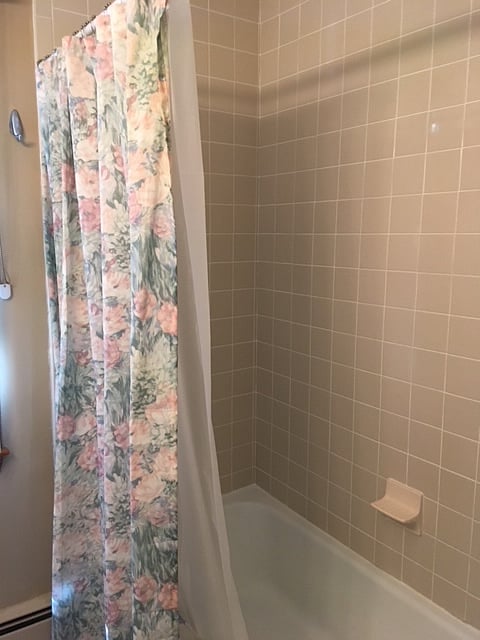 Full Bath with Bathtub , Shower and storage shelves for Linens , Towels and necessities . 