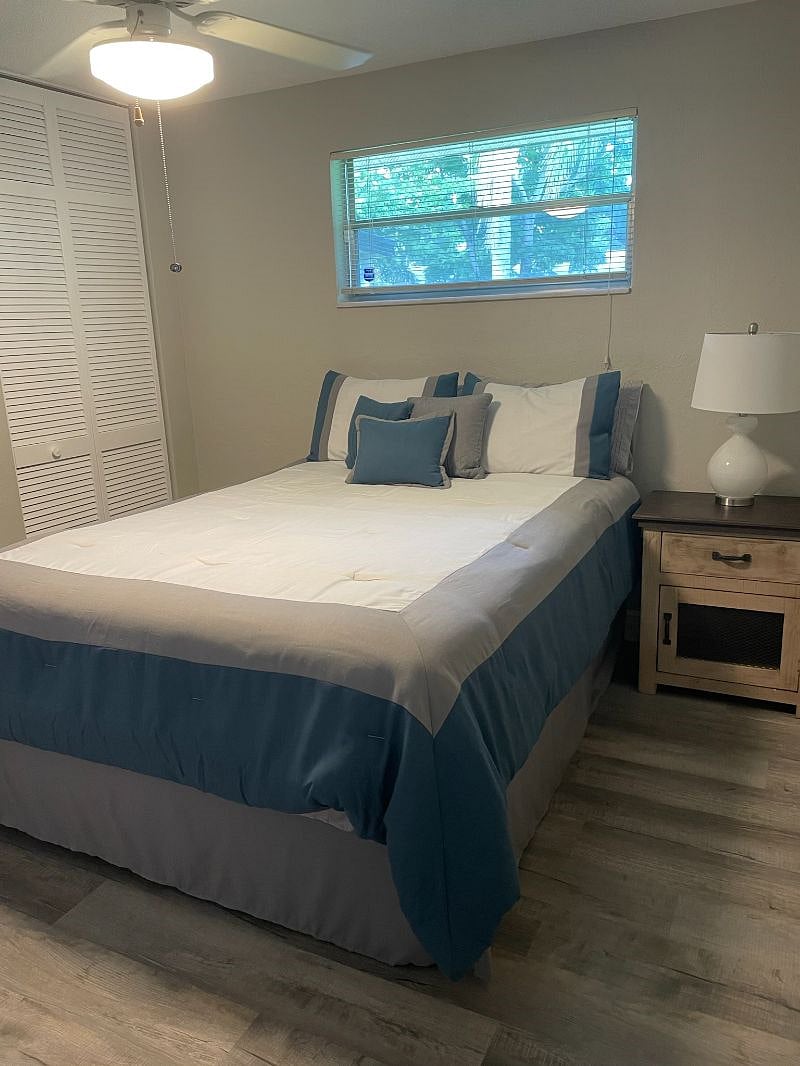 Guest room with smart TV and queen size bed.