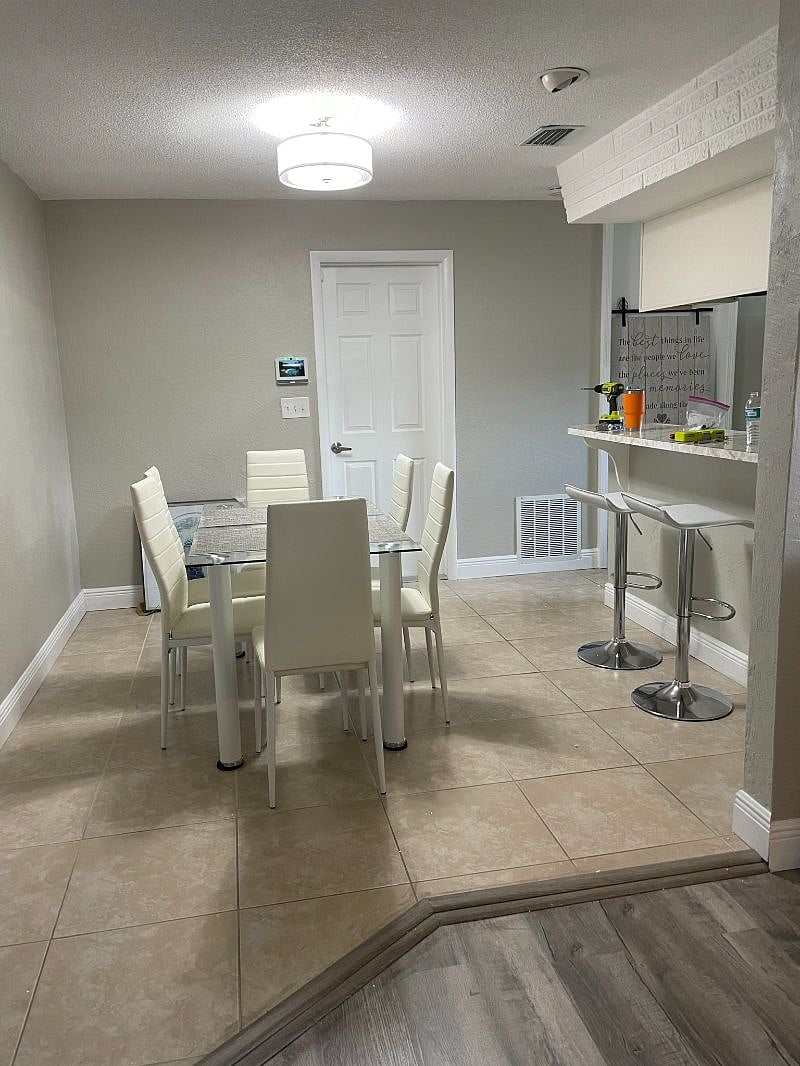 Spacious kitchen dining and bar. Open to family room and easy access to large two car garage with washer and dryer.