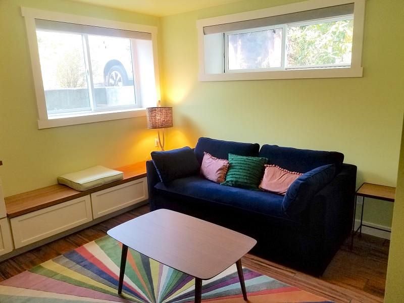 TV room has a tv, sleeper sofa, and extra storage.