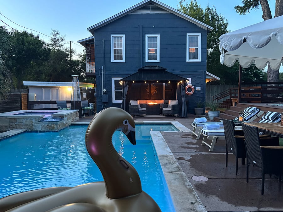 Your private backyard retreat featuring a sparkling pool, hot tub, and relaxing outdoor spaces to unwind after work.
