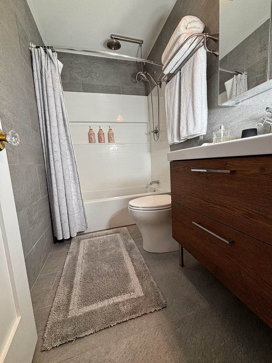Clean, modern bathroom stocked with fresh towels and essentials for a comfortable stay.