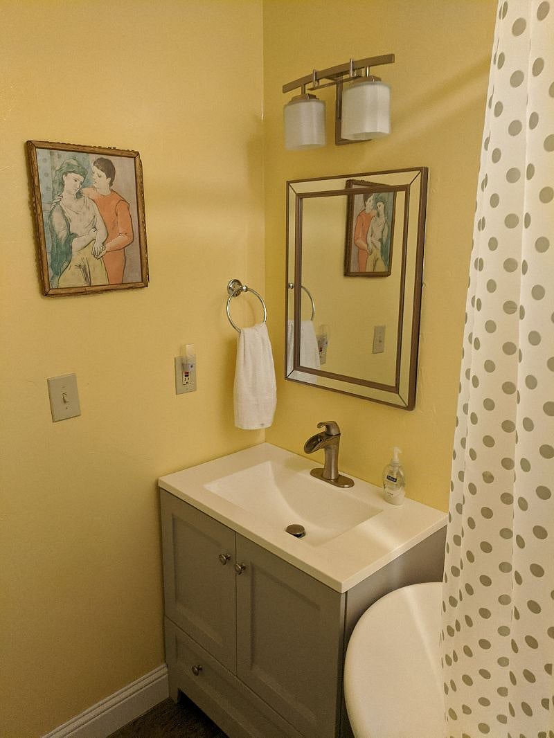 Bathroom vanity to the left of the tub.