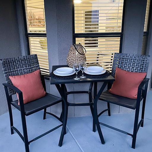 Bistro seating on large covered deck, with solar lights.