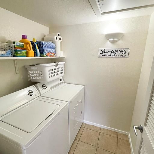Interior laundry room with full size washer/dryer.
