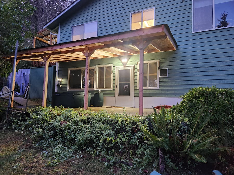 door going into the unit, patio has a 4-person hot tub & a propane firepit with chairs.