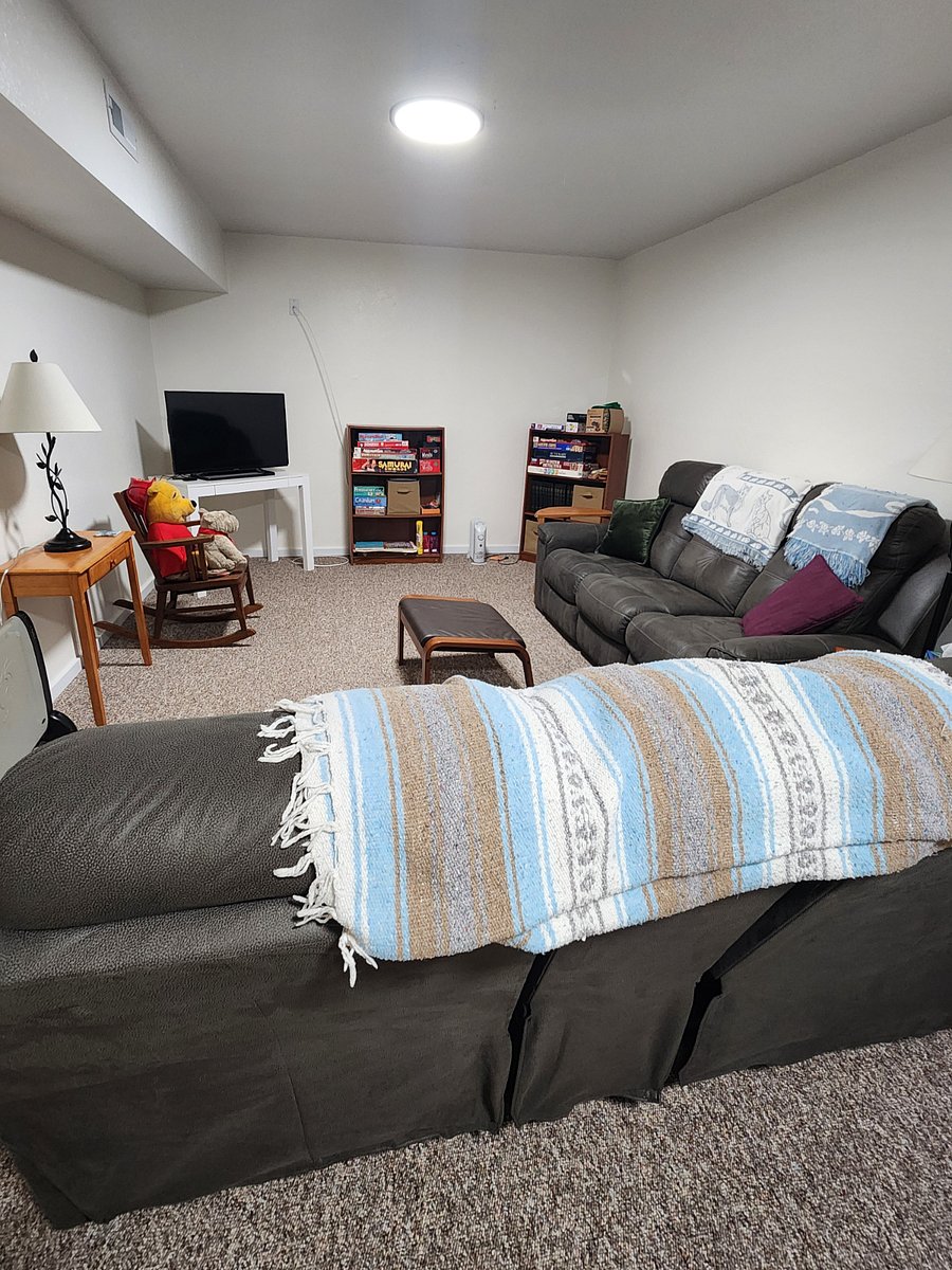 2nd view of front room with television & games,
