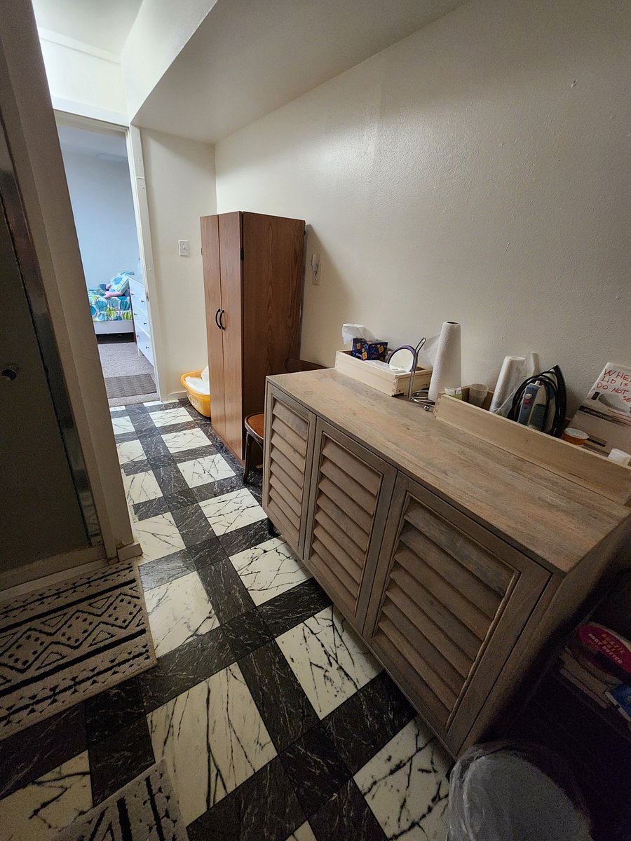 2nd view of the bathroom with linen closet for sheets and cupboard for towels