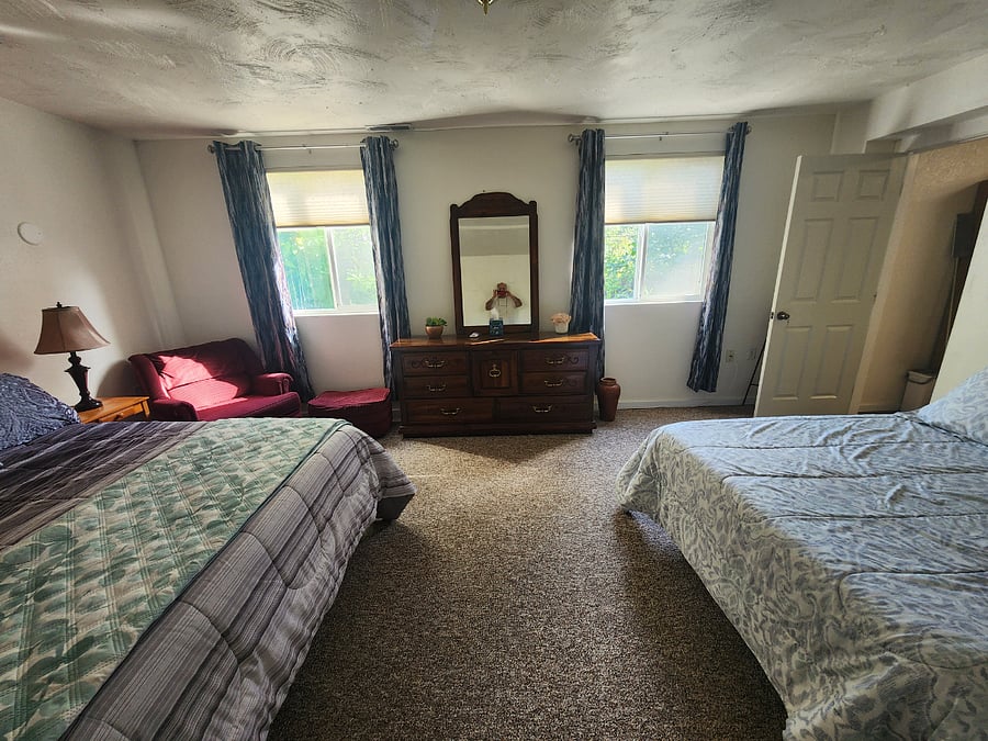 1st bedroom with two large windows