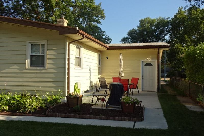 Back patio with gas grill.  Door is door to garage which leads to the secondary exit for the basement.